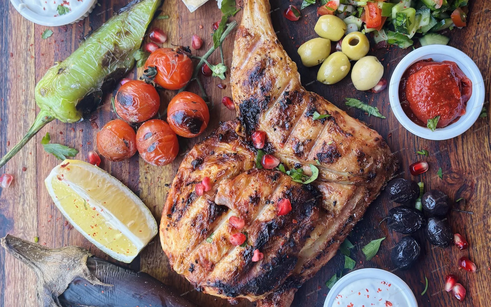 Charcoal grilled chicken with flatbread, salads, olives and harissa at Al Casbah